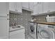 Bright laundry room with stylish tile and modern appliances at 2536 E Wood Pl, Chandler, AZ 85249