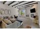 Living room with sectional sofa, fireplace, and exposed wooden beams at 2536 E Wood Pl, Chandler, AZ 85249