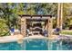 Beautiful stone and wood pergola with a built-in fireplace and comfortable seating at 2536 E Wood Pl, Chandler, AZ 85249