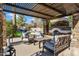 Outdoor entertainment area with a pergola, fireplace, and comfortable seating at 2536 E Wood Pl, Chandler, AZ 85249