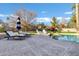 Beautiful pool and patio area with a striped umbrella and comfortable seating at 2536 E Wood Pl, Chandler, AZ 85249