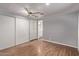 Bright bedroom with wood floors, ceiling fan, and mirrored closet doors at 2650 W Union Hills Dr # 352, Phoenix, AZ 85027