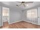 Bedroom with wood floors, ceiling fan, and access to bathroom at 2650 W Union Hills Dr # 352, Phoenix, AZ 85027