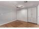 Bright bedroom with wood floors, ceiling fan, and mirrored closet doors at 2650 W Union Hills Dr # 352, Phoenix, AZ 85027