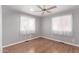 Bedroom with wood floors, ceiling fan and two windows at 2650 W Union Hills Dr # 352, Phoenix, AZ 85027