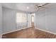 Bedroom with wood floors, ceiling fan, and window with sheer curtains at 2650 W Union Hills Dr # 352, Phoenix, AZ 85027