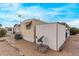 View of the mobile home from the side, showing the shed and satellite dish at 2650 W Union Hills Dr # 352, Phoenix, AZ 85027