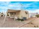 Tan mobile home with covered patio and gravel landscaping at 2650 W Union Hills Dr # 352, Phoenix, AZ 85027