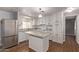 White kitchen cabinets, granite countertops and island at 2650 W Union Hills Dr # 352, Phoenix, AZ 85027