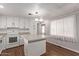 White kitchen cabinets, granite countertops and island at 2650 W Union Hills Dr # 352, Phoenix, AZ 85027