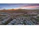 Aerial view of a residential area with mountains in the background at sunrise or sunset, showcasing the community at 32722 N 132Nd Ln, Peoria, AZ 85383