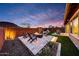 Backyard with firepit, patio, desert landscaping, play structure and stunning sunset views at 32722 N 132Nd Ln, Peoria, AZ 85383