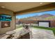 Backyard patio featuring comfortable seating, a fire pit, a water feature, and beautiful mountain views at 32722 N 132Nd Ln, Peoria, AZ 85383