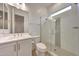 Bright bathroom features a glass enclosed shower with penny tile accent, and modern vanity at 32722 N 132Nd Ln, Peoria, AZ 85383