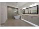 Luxurious bathroom with modern tub, decorative backsplash, and under cabinet lights at 32722 N 132Nd Ln, Peoria, AZ 85383