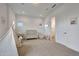 Bright Bedroom with large windows, a crib, comfortable seating and decor at 32722 N 132Nd Ln, Peoria, AZ 85383