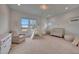 Bright Bedroom with large windows, a crib, comfortable seating and decor at 32722 N 132Nd Ln, Peoria, AZ 85383