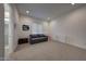 Bright bonus room features neutral carpet, recessed lighting, and a comfortable gray sofa at 32722 N 132Nd Ln, Peoria, AZ 85383