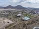 Aerial view of community pool, clubhouse, and surrounding landscape at 32722 N 132Nd Ln, Peoria, AZ 85383