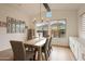 Bright dining room features natural light, wooden floors, and stylish table setting at 32722 N 132Nd Ln, Peoria, AZ 85383