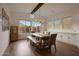 Bright dining room features natural light, wooden floors, and stylish table setting at 32722 N 132Nd Ln, Peoria, AZ 85383