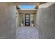 Entrance featuring custom paver flooring with black door at 32722 N 132Nd Ln, Peoria, AZ 85383