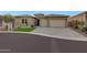 Beautiful home featuring desert landscaping, a three-car garage, and a curved driveway at 32722 N 132Nd Ln, Peoria, AZ 85383