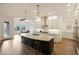Modern kitchen has large island with seating, stainless steel appliances, and bright white cabinetry at 32722 N 132Nd Ln, Peoria, AZ 85383