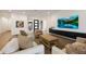 Stylish living room featuring hardwood floors, modern decor, and a large screen television at 32722 N 132Nd Ln, Peoria, AZ 85383