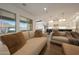 Bright living area boasts large windows, comfortable seating, and views of the outdoor landscape at 32722 N 132Nd Ln, Peoria, AZ 85383