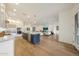 Open living space combines kitchen, living and dining, with hardwood flooring at 32722 N 132Nd Ln, Peoria, AZ 85383