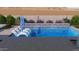 Backyard pool with with built in water feature, in-pool seating and desert landscaping at 32722 N 132Nd Ln, Peoria, AZ 85383