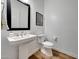 Powder room features modern fixtures, wood look tile flooring, and a floating vanity at 32722 N 132Nd Ln, Peoria, AZ 85383