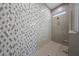 Walk-in shower featuring a mosaic tiled wall, shower head, and window at 32722 N 132Nd Ln, Peoria, AZ 85383