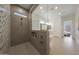 Walk-in shower with gray tile, shower products niche, and a glass partition at 32722 N 132Nd Ln, Peoria, AZ 85383