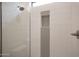 Close up of the glass enclosed shower, featuring penny tile accent and brushed nickel fixtures at 32722 N 132Nd Ln, Peoria, AZ 85383