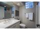 Simple bathroom with a single sink vanity, toilet, and glass block window at 32900 N 69Th St, Scottsdale, AZ 85266