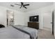 Main bedroom with large TV, dresser, and walk-in closet at 40108 W Crane Dr, Maricopa, AZ 85138