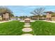 Peaceful community lake with stone seating area at 40108 W Crane Dr, Maricopa, AZ 85138