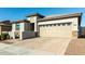 Modern house exterior with a two-car garage and neutral colors at 40108 W Crane Dr, Maricopa, AZ 85138