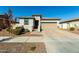Single-story home with a two-car garage and landscaped front yard at 40108 W Crane Dr, Maricopa, AZ 85138