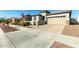 Single-story house with a large driveway and neutral-colored facade at 40108 W Crane Dr, Maricopa, AZ 85138