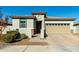 Modern single story home with tan garage door and neutral color scheme at 40108 W Crane Dr, Maricopa, AZ 85138