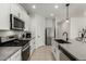 Modern kitchen features stainless steel appliances and gray countertops at 40108 W Crane Dr, Maricopa, AZ 85138