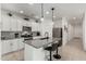 Modern kitchen with white cabinets, gray countertops, and a kitchen island at 40108 W Crane Dr, Maricopa, AZ 85138