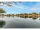 Serene lake view with tree-lined shores at 40108 W Crane Dr, Maricopa, AZ 85138