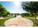 Stone pathway leading to a tranquil lake view at 40108 W Crane Dr, Maricopa, AZ 85138