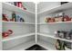 Well-organized pantry with ample shelving for storage at 40108 W Crane Dr, Maricopa, AZ 85138