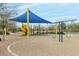 Playground with shade structure and swings at 40108 W Crane Dr, Maricopa, AZ 85138