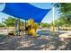playground with shade structure, slide, and play equipment at 40108 W Crane Dr, Maricopa, AZ 85138
